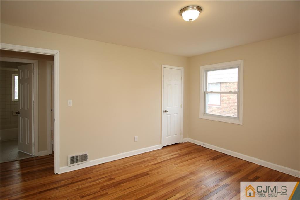 10 Gurley Road Edison, NJ 08817 - Photo 10 of 17 a view of an empty room with wooden floor and a window
