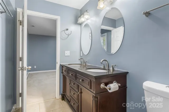 a bathroom with a sink vanity and a mirror