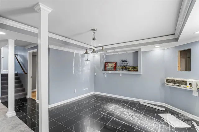 a view of a livingroom with wooden floor and white walls