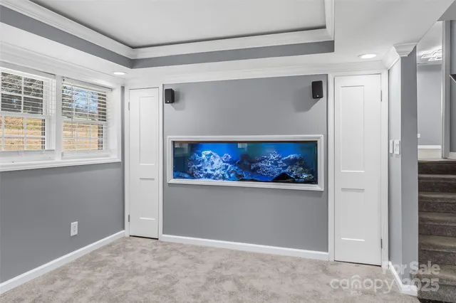 a view of an empty room with a painting on the wall