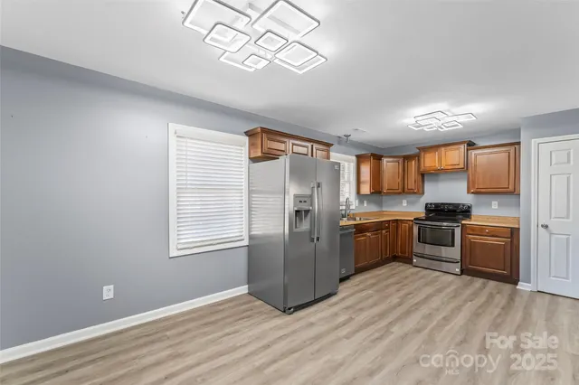 a kitchen with granite countertop stainless steel appliances cabinets a sink and a counter top space