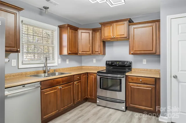 a kitchen with a sink stove and cabinets