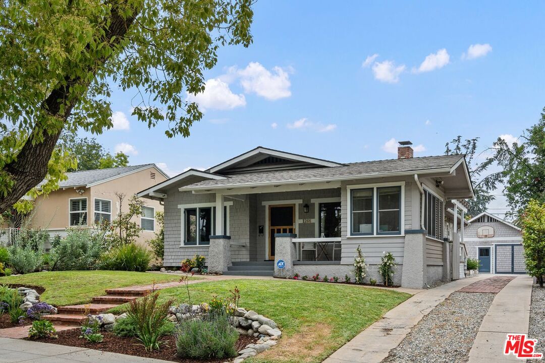 a front view of a house with a garden
