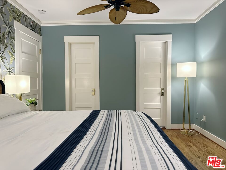 1266 Wesley Avenue Pasadena, CA 91104 - Photo 16 of 25 a bedroom with a bed and a chandelier