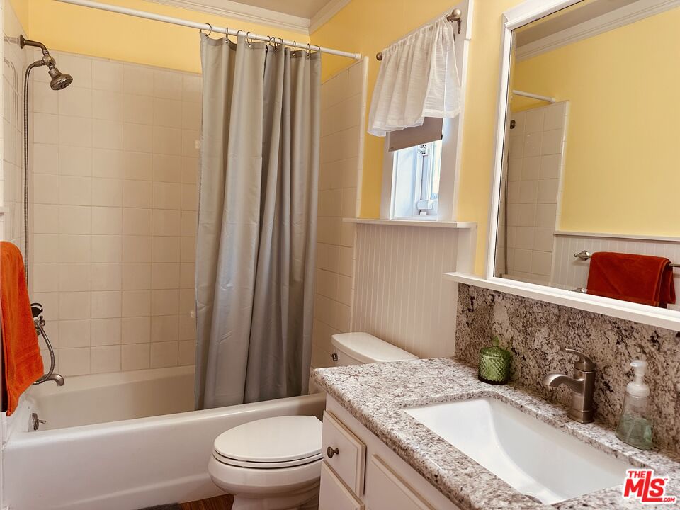 1266 Wesley Avenue Pasadena, CA 91104 - Photo 17 of 25 a bathroom with a granite countertop sink toilet and shower