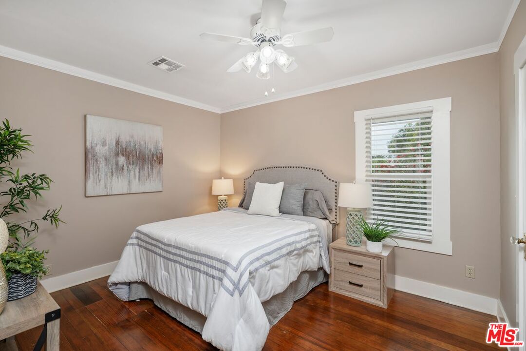 1266 Wesley Avenue Pasadena, CA 91104 - Photo 19 of 25 a bedroom with a bed and a window