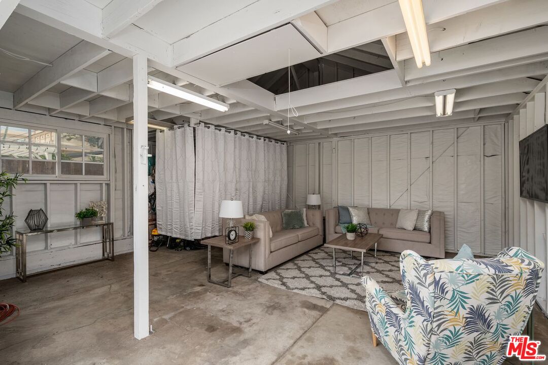 1266 Wesley Avenue Pasadena, CA 91104 - Photo 24 of 25 a living room with furniture and a chandelier