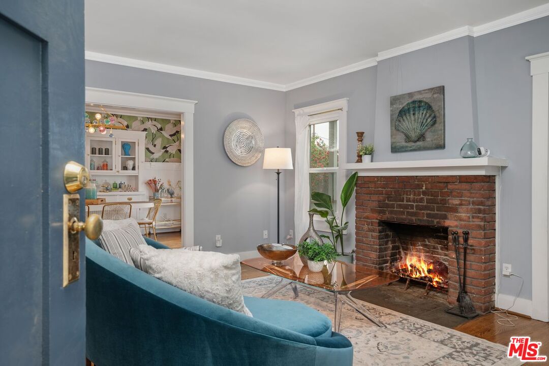 1266 Wesley Avenue Pasadena, CA 91104 - Photo 4 of 25 a living room with furniture and a fireplace