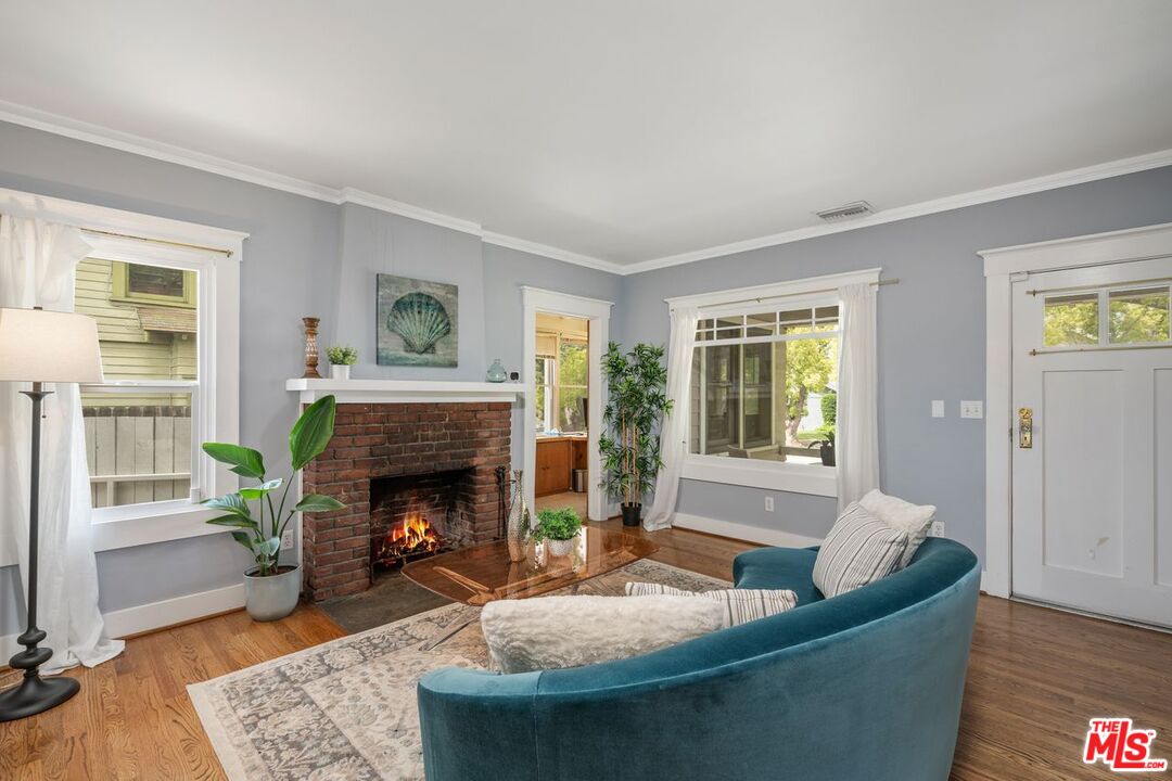 1266 Wesley Avenue Pasadena, CA 91104 - Photo 5 of 25 a living room with furniture and a fireplace