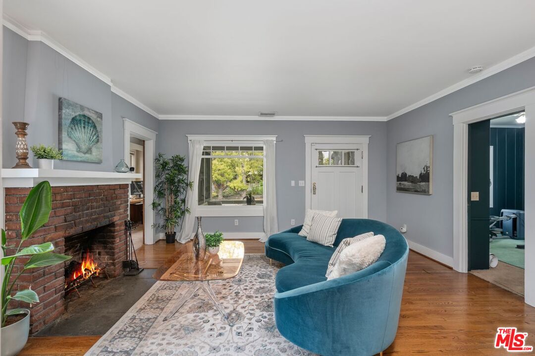 1266 Wesley Avenue Pasadena, CA 91104 - Photo 6 of 25 a living room with furniture and a fireplace