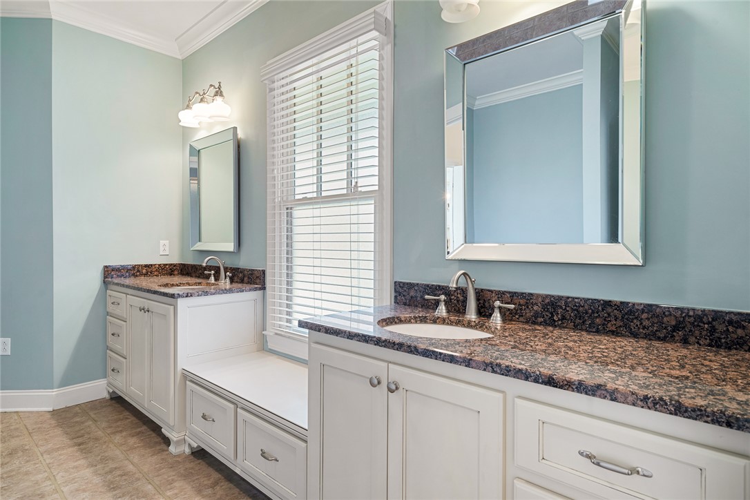 16 Oleander Drive Anderson, SC 29621 - Photo 24 of 37 Two individual vanities featuring stone counters and sleek cabinetry define this well-appointed bathroom.