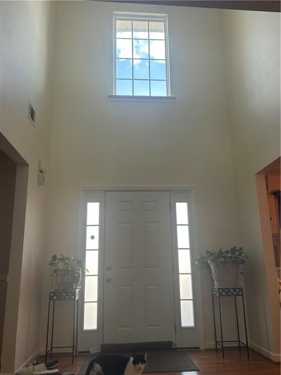 769 Roxholly Lane Northeast Buford, GA 30518 - Photo 16 of 81 a view of an empty room with wooden floor and a window