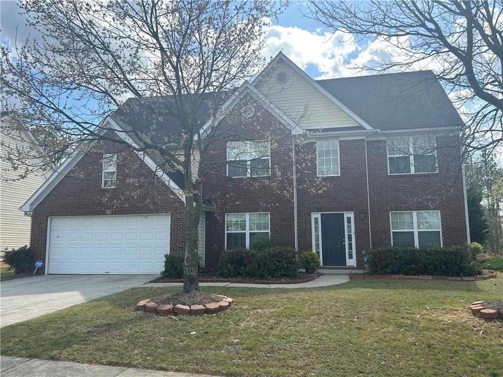 769 Roxholly Lane Northeast Buford, GA 30518 - Photo 2 of 81 a front view of a house with a yard and garage
