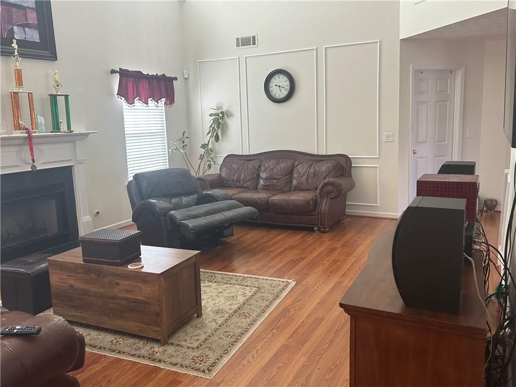 769 Roxholly Lane Northeast Buford, GA 30518 - Photo 26 of 81 a living room with furniture and a fireplace