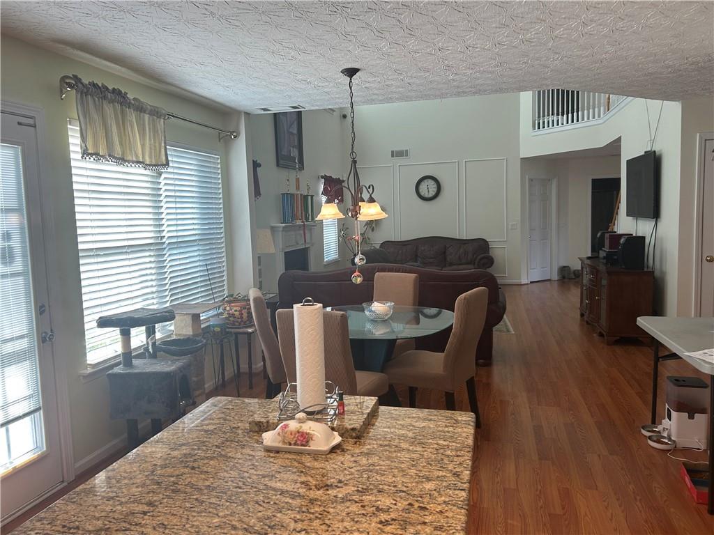 769 Roxholly Lane Northeast Buford, GA 30518 - Photo 27 of 81 a living room with furniture windows and wooden floor