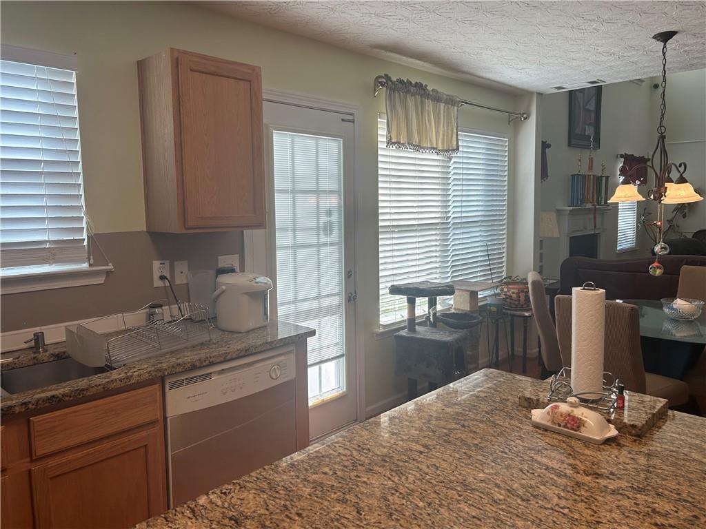 769 Roxholly Lane Northeast Buford, GA 30518 - Photo 28 of 81 a kitchen with granite countertop sink and cabinets