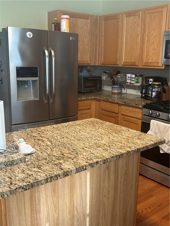 769 Roxholly Lane Northeast Buford, GA 30518 - Photo 30 of 81 a kitchen with stainless steel appliances granite countertop a sink refrigerator and cabinets