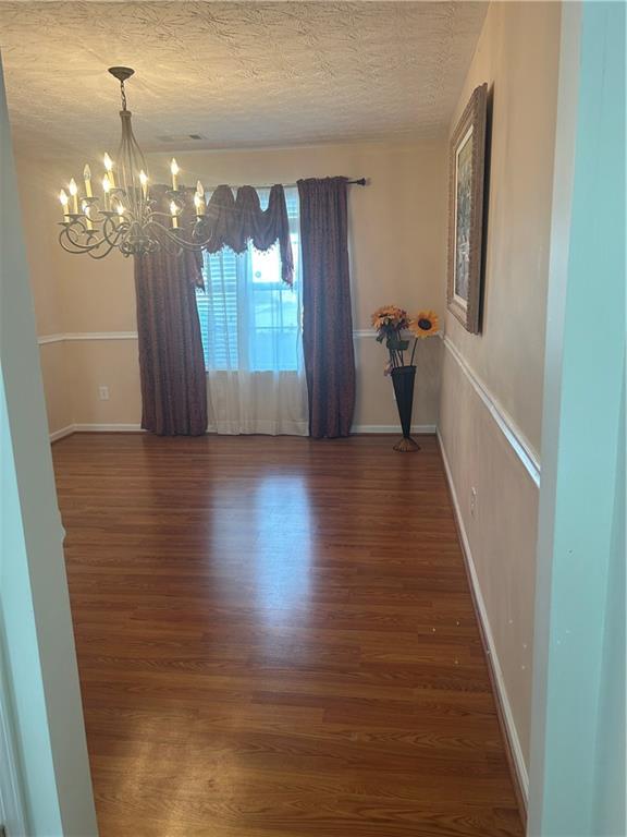 769 Roxholly Lane Northeast Buford, GA 30518 - Photo 34 of 81 a view of a hallway with wooden floor and chandelier