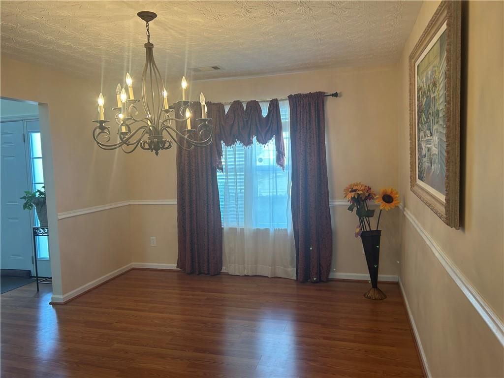 769 Roxholly Lane Northeast Buford, GA 30518 - Photo 36 of 81 a view of a hallway with wooden floor and stairs