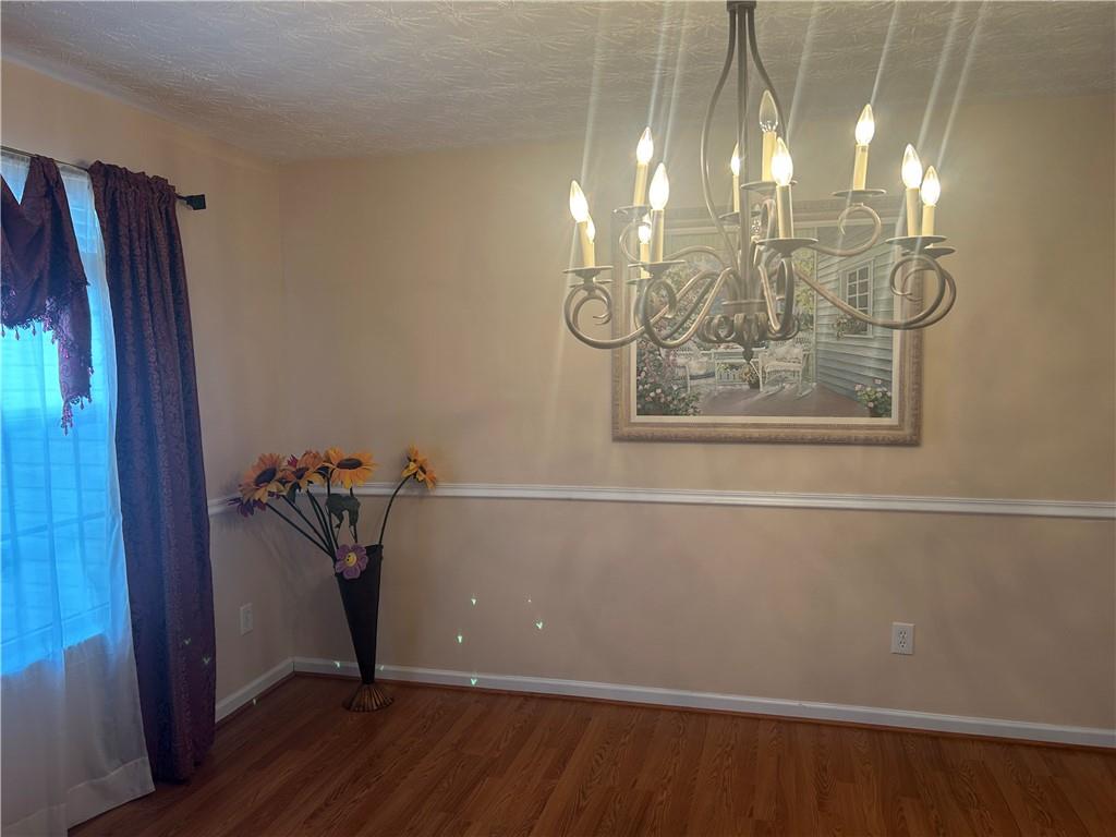 769 Roxholly Lane Northeast Buford, GA 30518 - Photo 40 of 81 a view of a room with wooden floor and windows