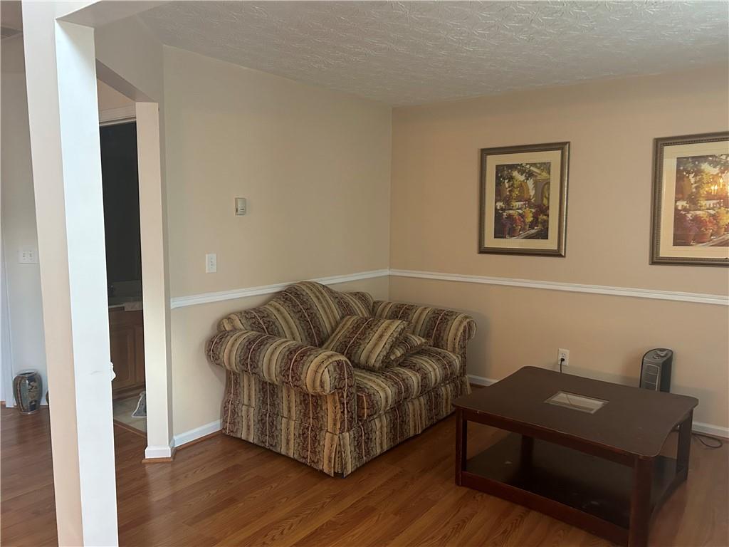 769 Roxholly Lane Northeast Buford, GA 30518 - Photo 43 of 81 a living room with furniture and a wooden floor