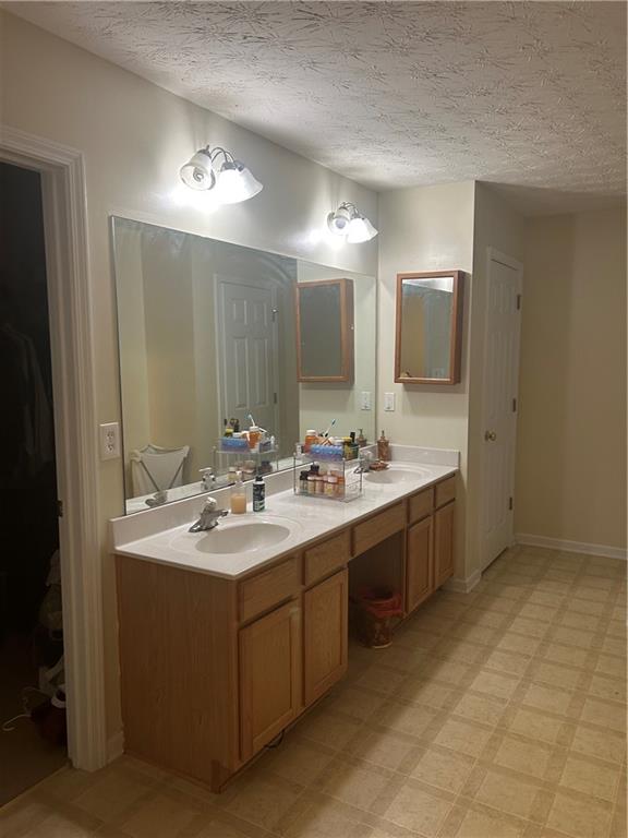 769 Roxholly Lane Northeast Buford, GA 30518 - Photo 54 of 81 a bathroom with a sink double vanity granite and a mirror