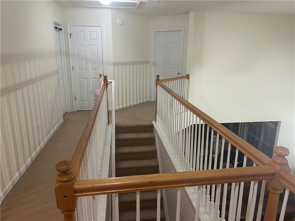 769 Roxholly Lane Northeast Buford, GA 30518 - Photo 63 of 81 a view of staircase with railing and white walls