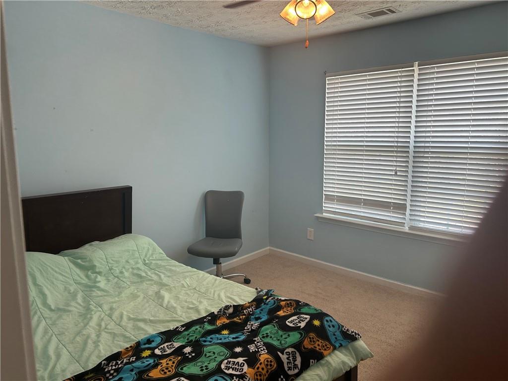 769 Roxholly Lane Northeast Buford, GA 30518 - Photo 67 of 81 a bedroom with a bed and a window