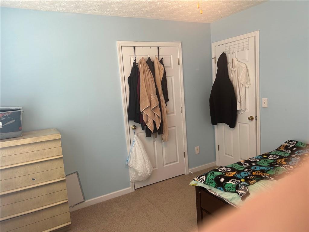769 Roxholly Lane Northeast Buford, GA 30518 - Photo 68 of 81 a view of walk in closet with clothes and shoes
