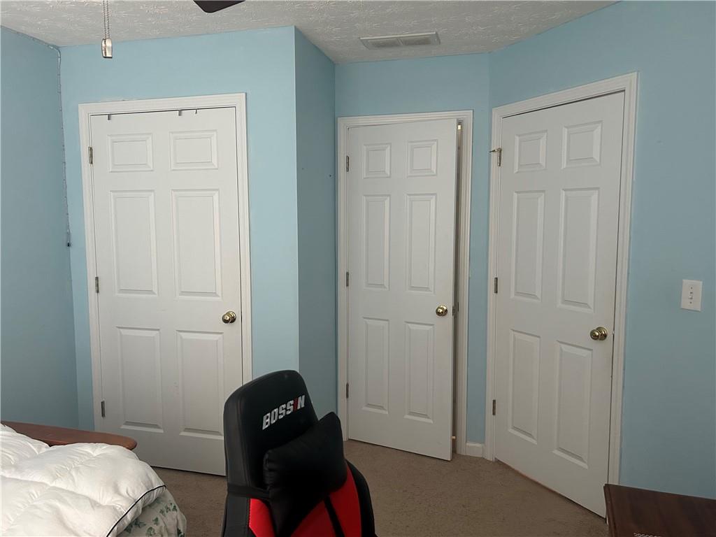 769 Roxholly Lane Northeast Buford, GA 30518 - Photo 75 of 81 a bedroom with a bed and a chair