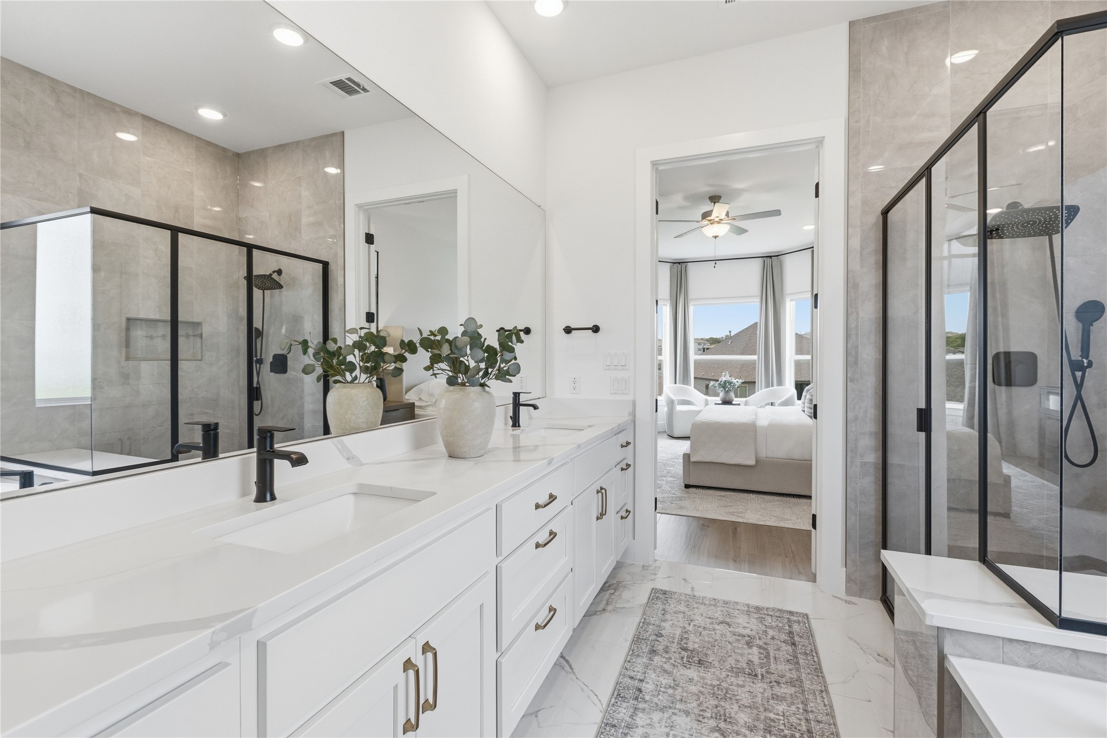 836 Villa Rialto View Leander, TX 78641 - Photo 15 of 33 Luxurious primary bathroom featuring a dual vanity, sleek glass-enclosed shower, and elegant tile flooring.