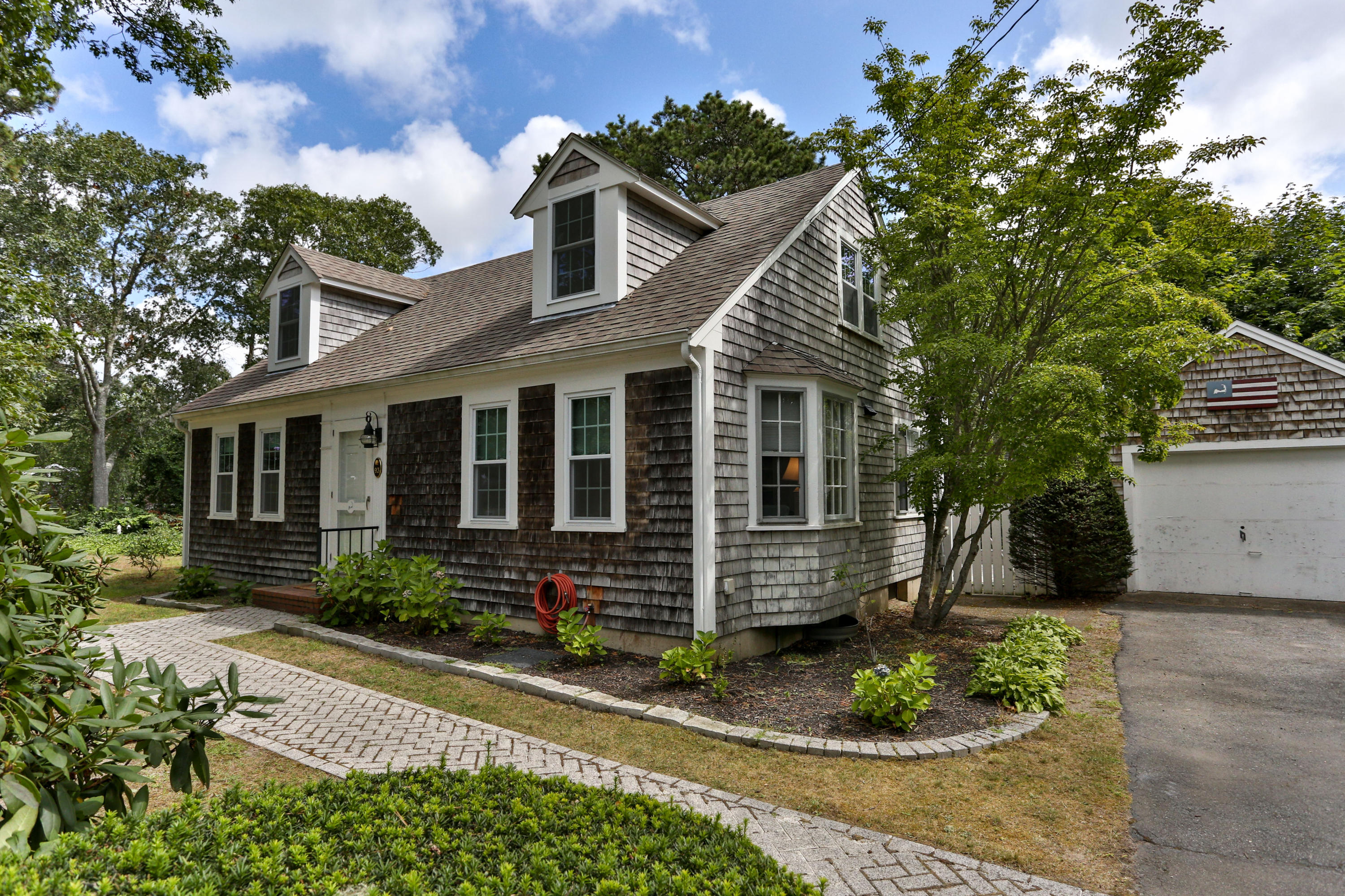 93 Brooks Road Harwich Port, MA 02646 - Photo 1 of 35 a front view of a house with a yard