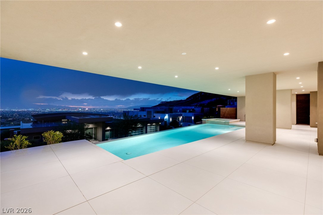 677 Overlook Rim Drive Henderson, NV 89012 - Photo 77 of 97 Smooth tiled surfaces frame an elegant lap pool overlooking dramatic city lights and mountain views.