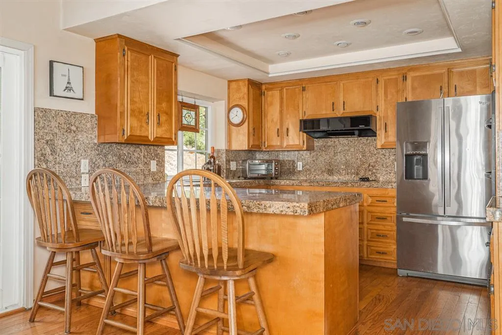 1307 Van Vechten Road El Cajon, CA 92019 - Photo 16 of 24 a kitchen with stainless steel appliances granite countertop a refrigerator and microwave