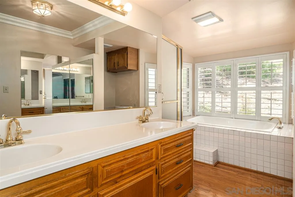 1307 Van Vechten Road El Cajon, CA 92019 - Photo 24 of 24 a spacious bathroom with sink a mirror a bathtub and next to a window