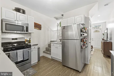 a kitchen with stainless steel appliances a refrigerator stove and microwave