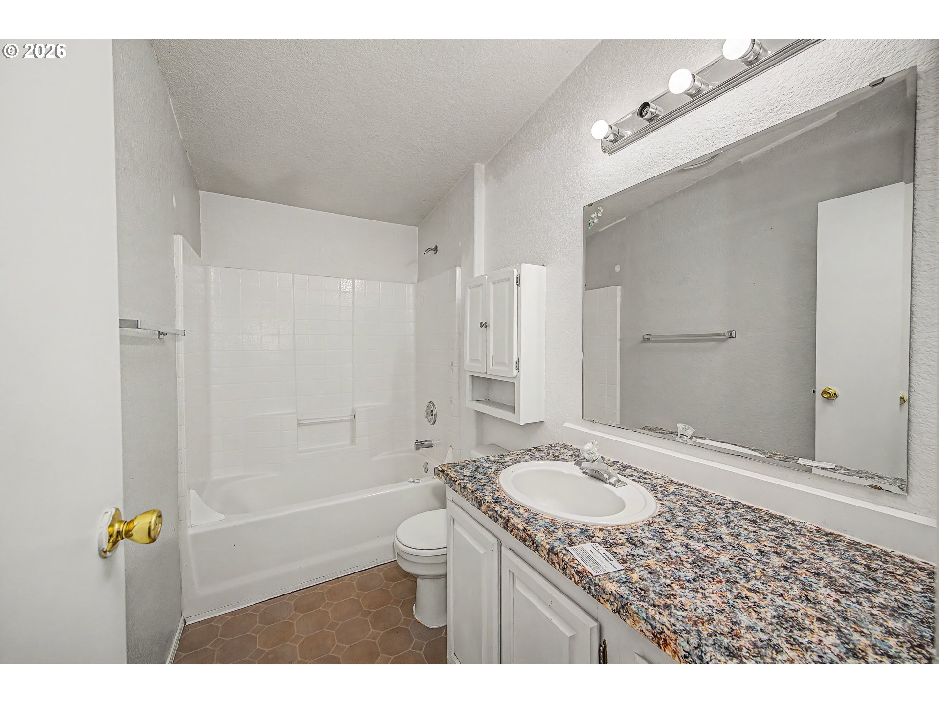 5510 E Street Springfield, OR 97478 - Photo 9 of 16 a bathroom with a granite countertop sink a toilet and shower