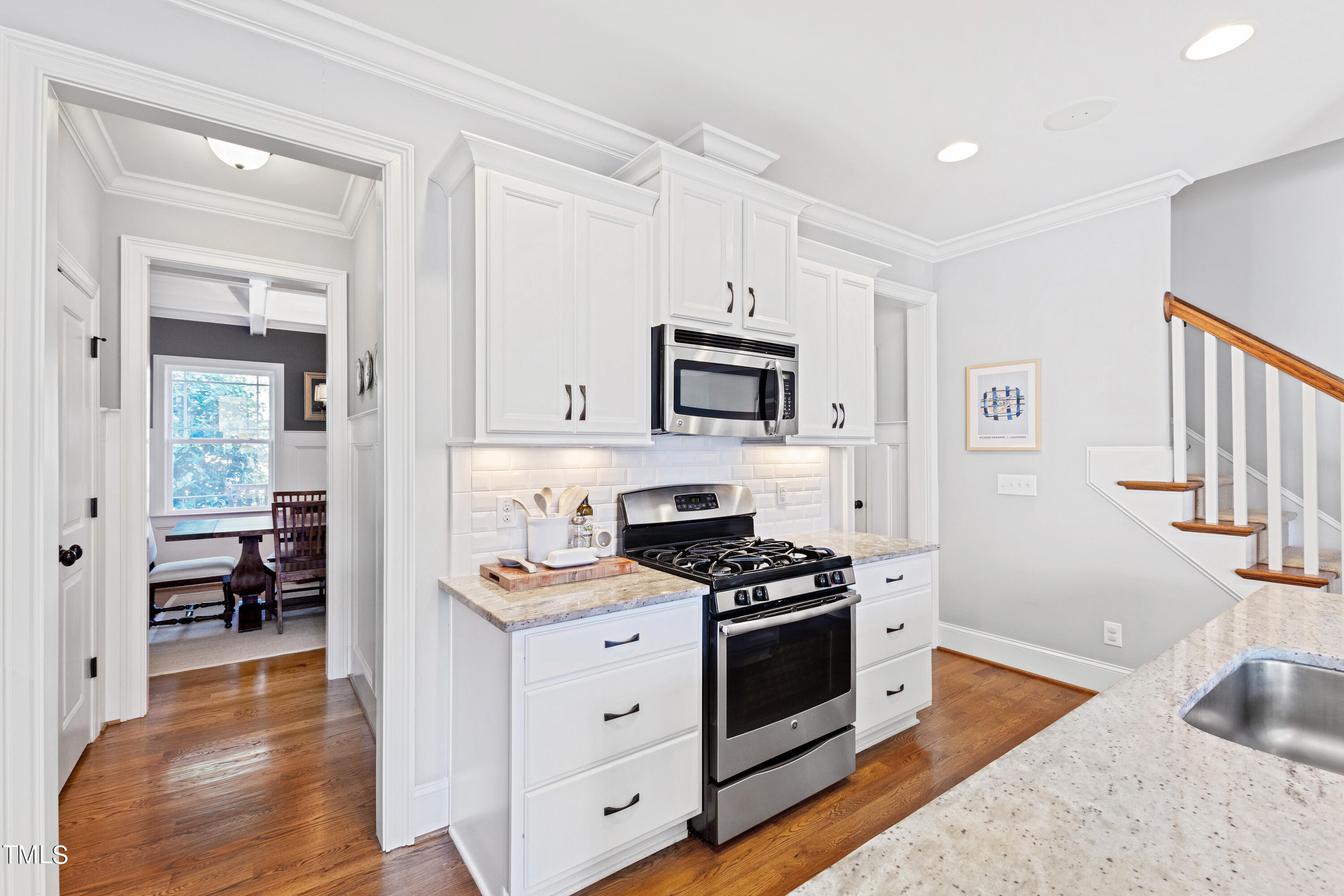 6213 Blanche Drive Raleigh, NC 27607 - Photo 12 of 48 a kitchen with white cabinets and appliances