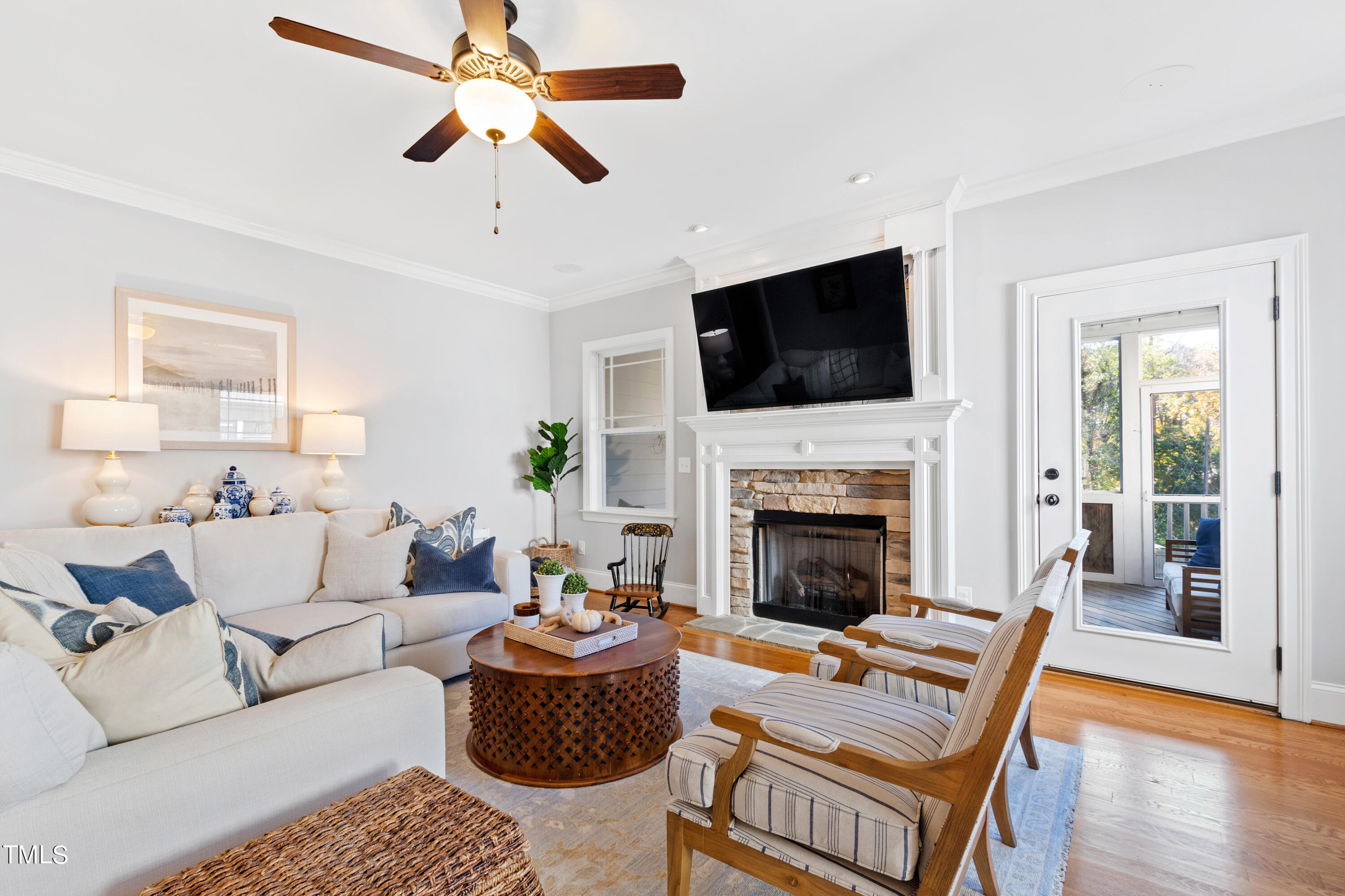 6213 Blanche Drive Raleigh, NC 27607 - Photo 15 of 48 a living room with furniture a fireplace and a flat screen tv