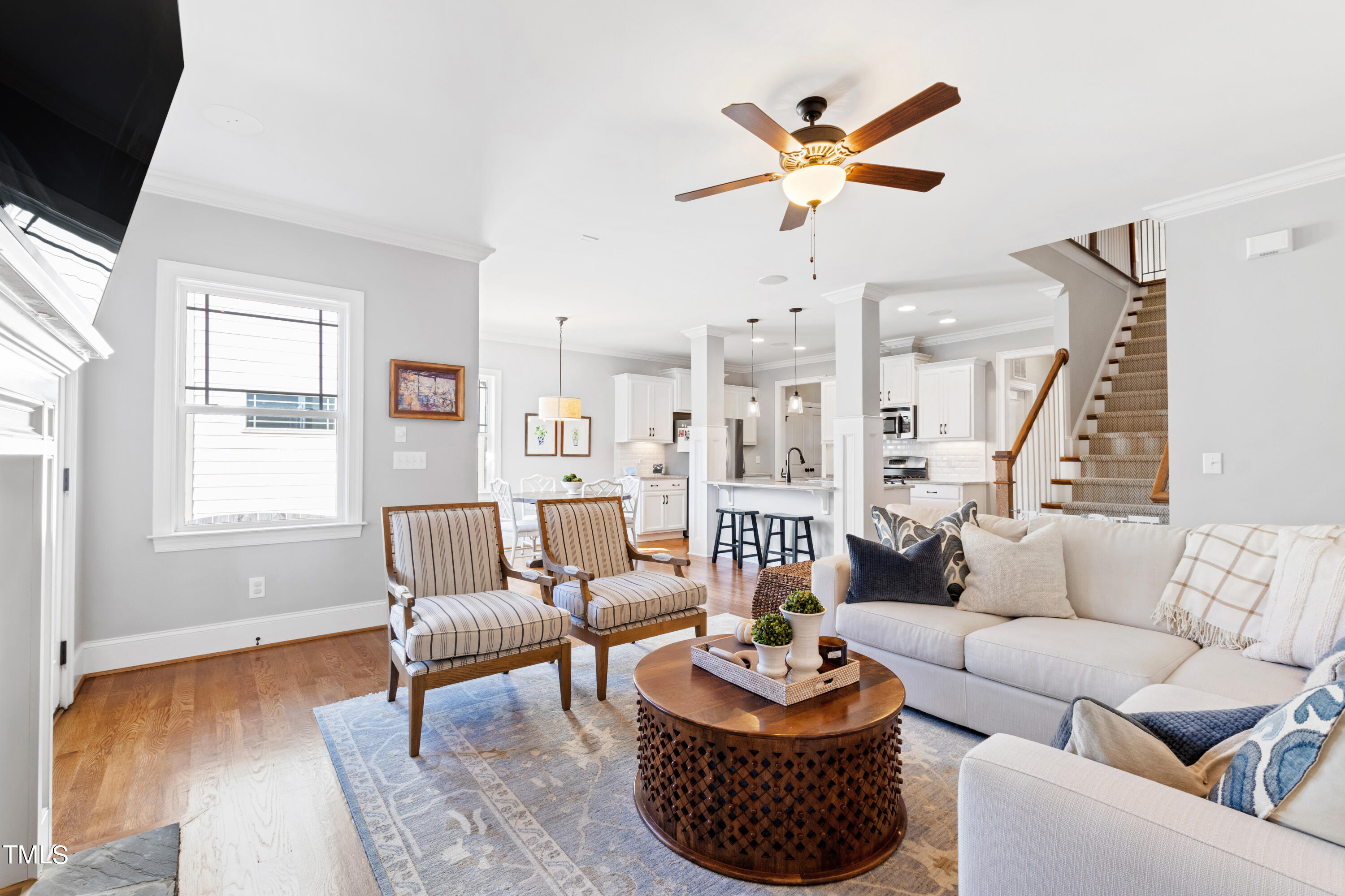 6213 Blanche Drive Raleigh, NC 27607 - Photo 17 of 48 a living room with furniture a rug and a chandelier