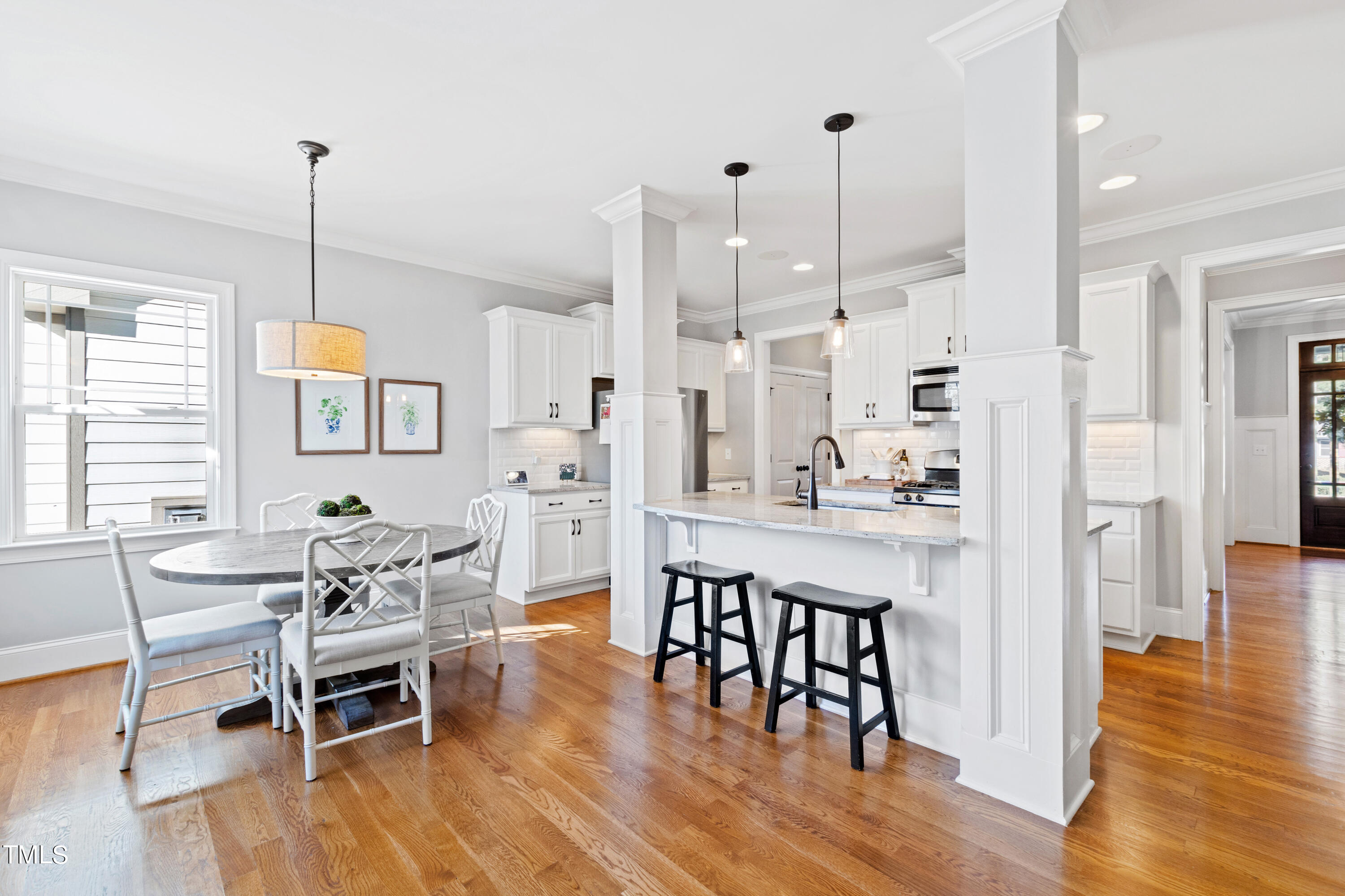 6213 Blanche Drive Raleigh, NC 27607 - Photo 19 of 48 a view of a dining room and livingroom with furniture wooden floor a chandelier