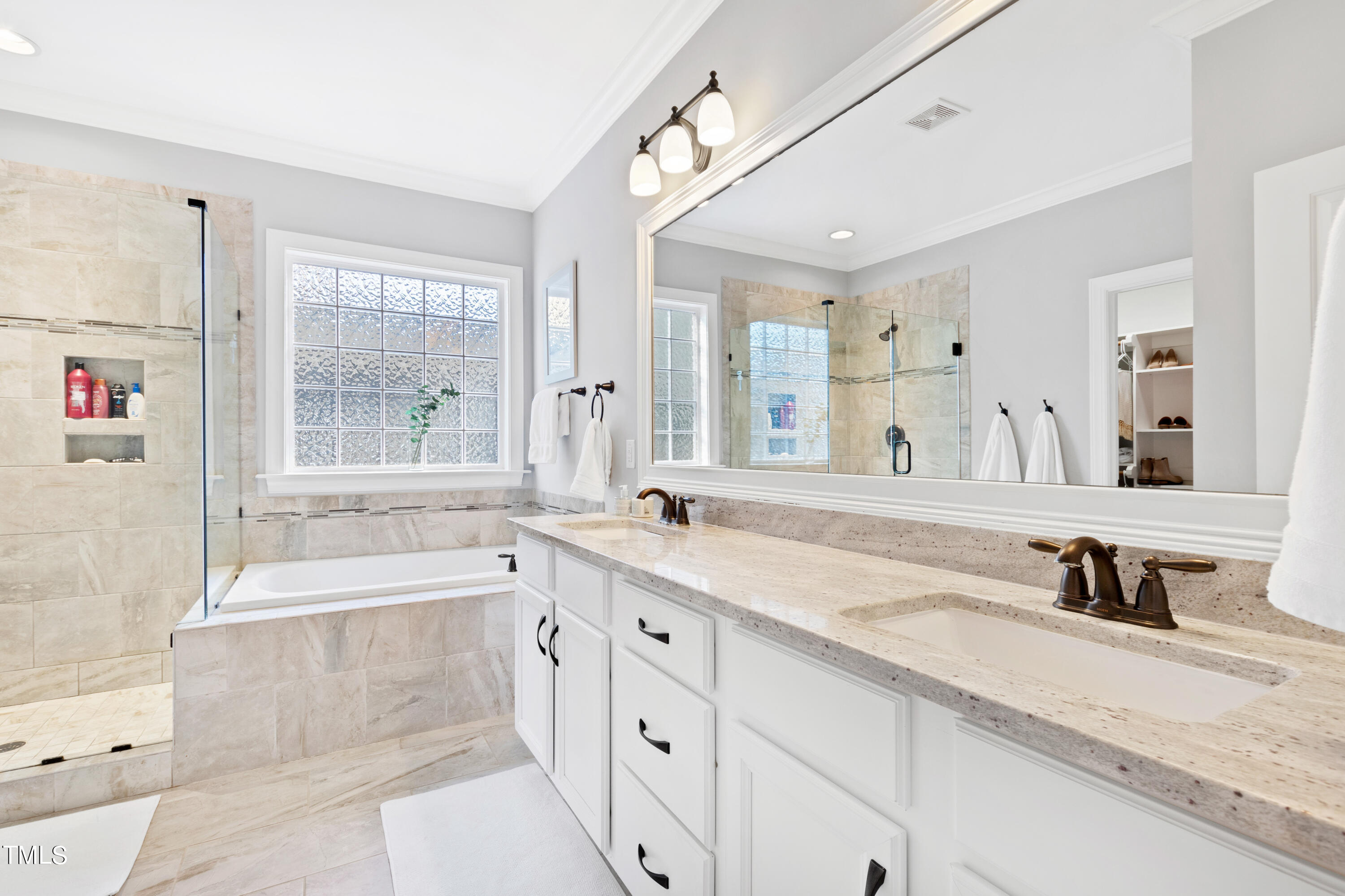 6213 Blanche Drive Raleigh, NC 27607 - Photo 23 of 48 a spacious bathroom with a tub sink and mirror