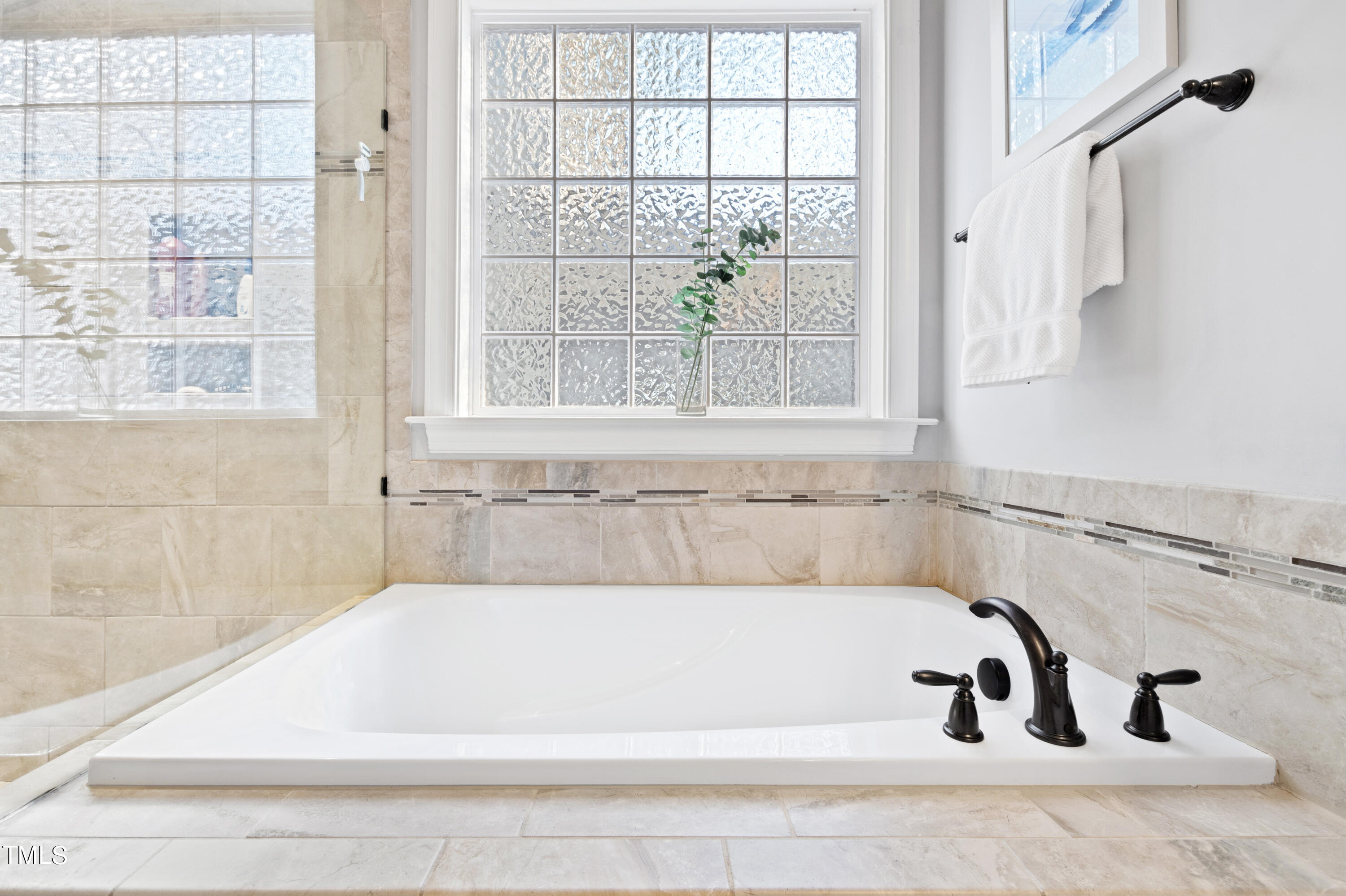 6213 Blanche Drive Raleigh, NC 27607 - Photo 25 of 48 a bathroom with bathtub and window