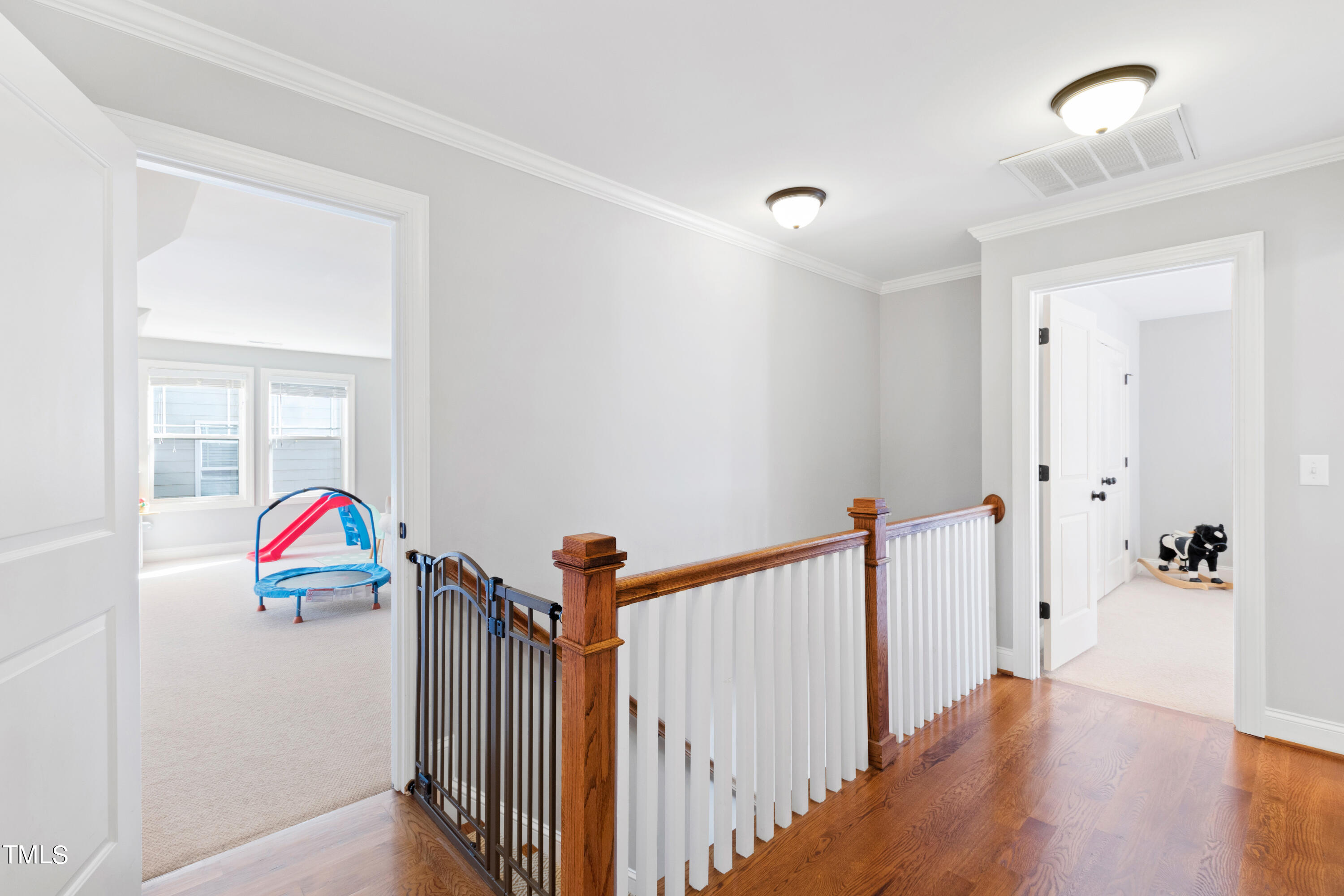 6213 Blanche Drive Raleigh, NC 27607 - Photo 30 of 48 a view of hallway with wooden floor and stairs
