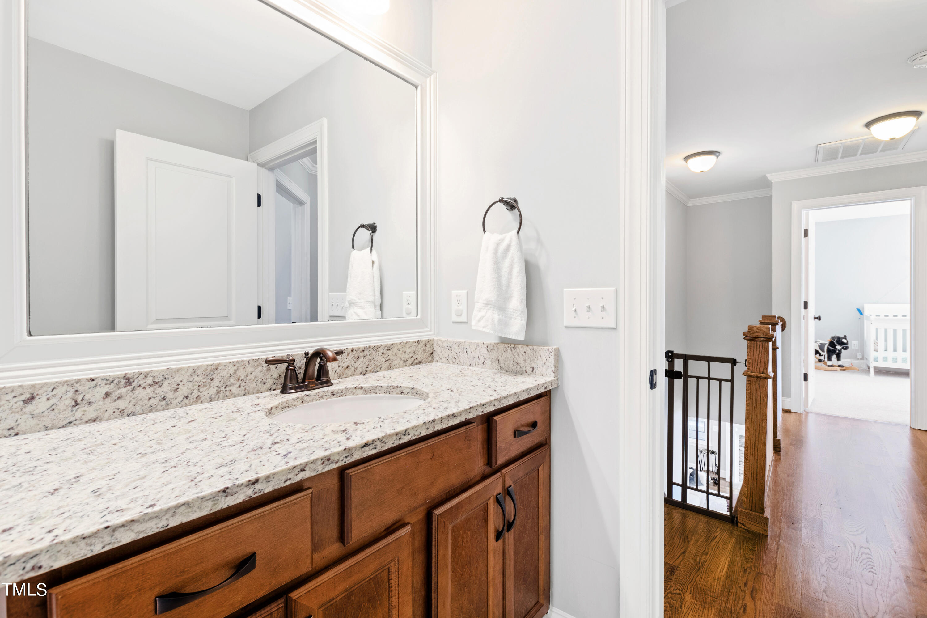 6213 Blanche Drive Raleigh, NC 27607 - Photo 35 of 48 a bathroom with a granite countertop sink and a mirror