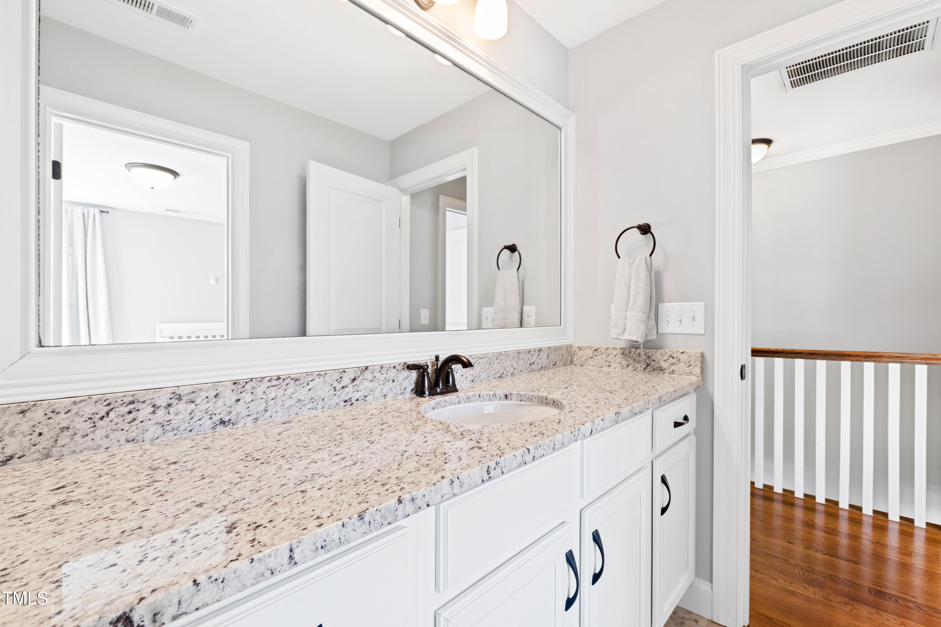 6213 Blanche Drive Raleigh, NC 27607 - Photo 37 of 48 a bathroom with a granite countertop sink and a mirror