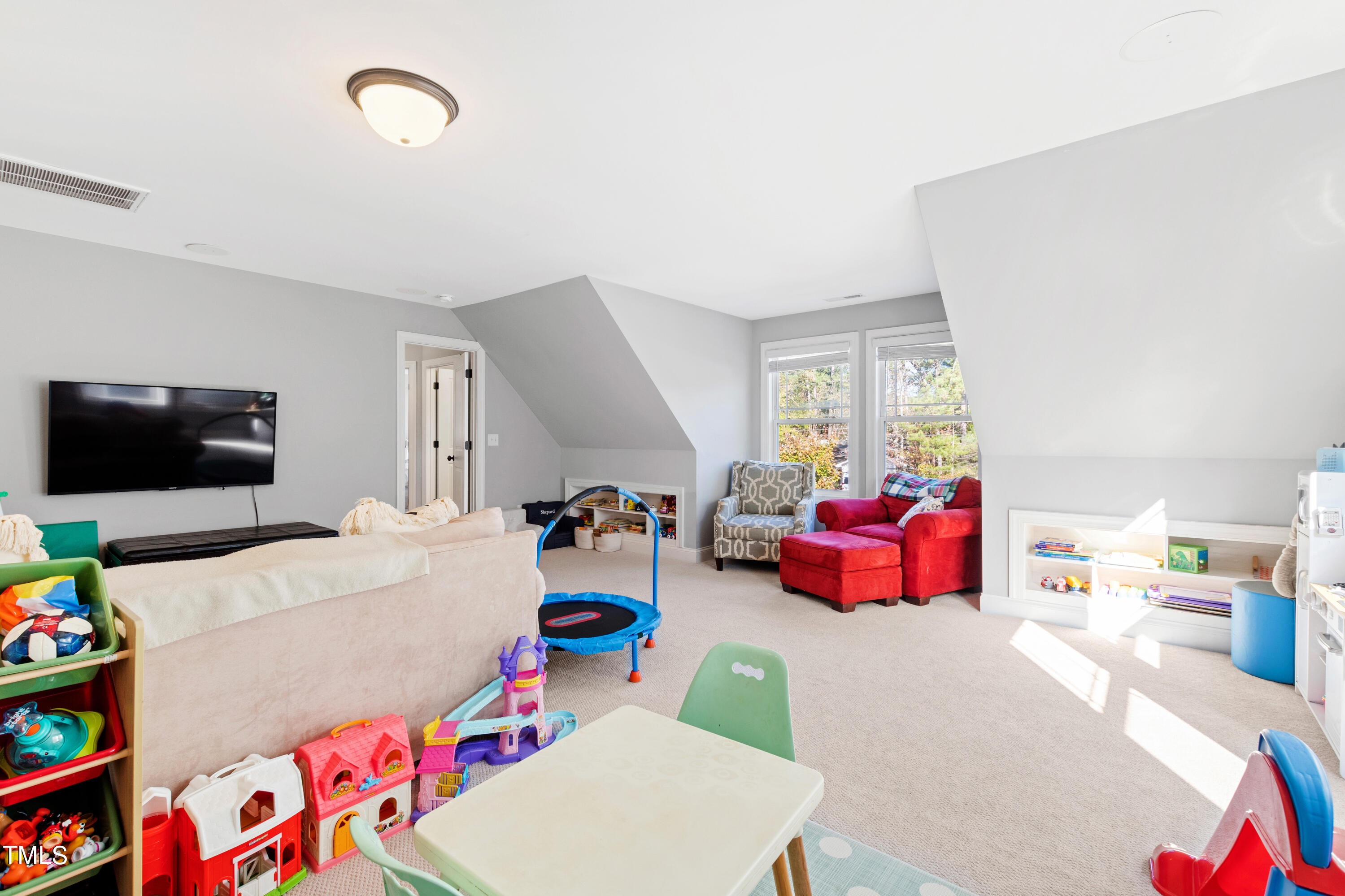 6213 Blanche Drive Raleigh, NC 27607 - Photo 40 of 48 a room with furniture a flat screen tv and a couch