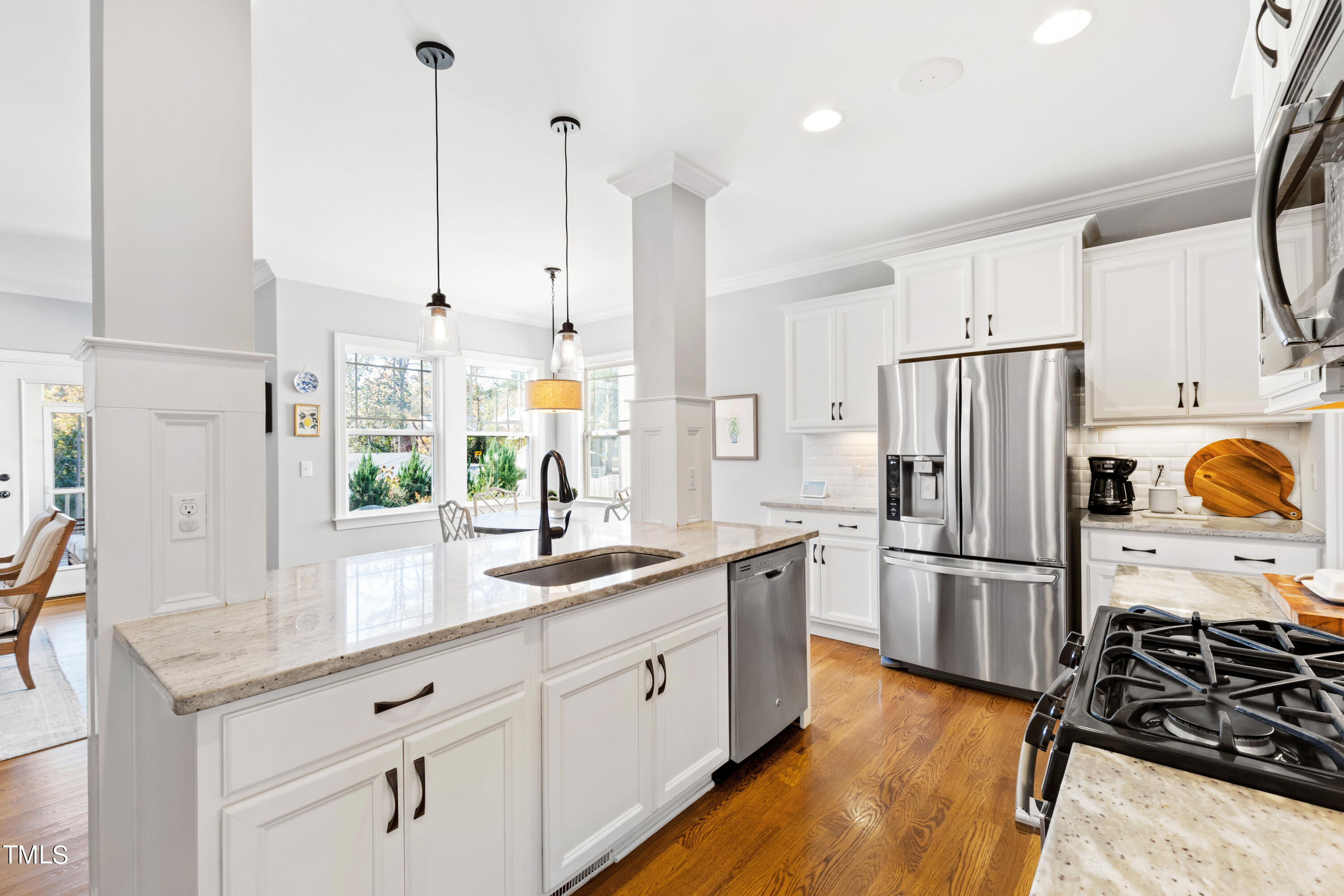 6213 Blanche Drive Raleigh, NC 27607 - Photo 9 of 48 a kitchen with stainless steel appliances a refrigerator sink and stove
