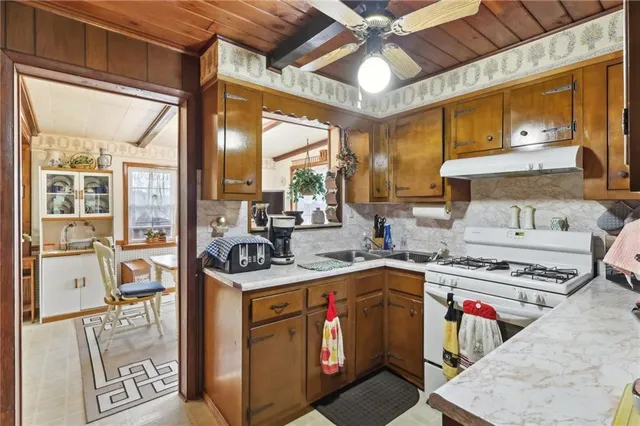 a kitchen with stainless steel appliances granite countertop a stove and a sink
