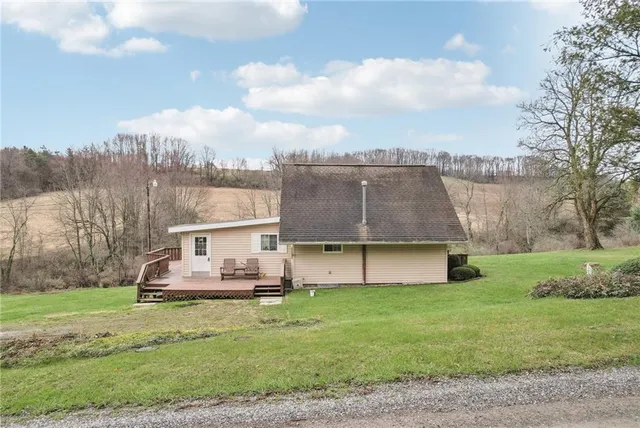 a view of a house with a backyard and a garden